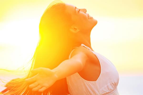 Image of Woman Enjoying Sunset